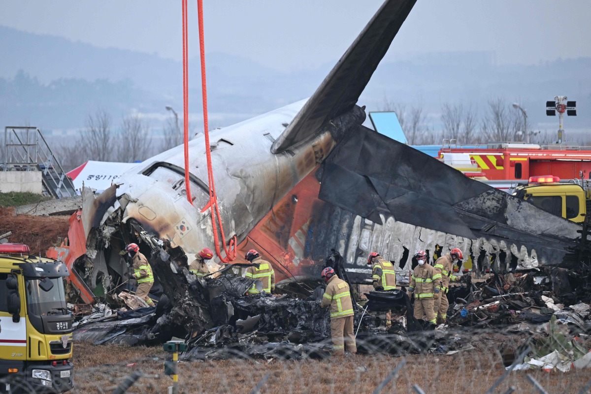 Firefighters and recovery teams work at the scene where a Jeju Air Boeing 737-800 series aircraft crashed and burst into flames at Muan International Airport in Muan, some 288 kilometres southwest of Seoul on December 30, 2024. Photo by JUNG YEON-JE / AFP