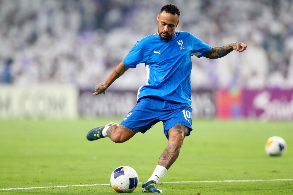 Hilal's Brazilian forward #10 Neymar warms up ahead of the AFC Champions League group B football match between UAE's Al Ain and Saudi's Al Hilal at the Hazza bin Zayed Stadium in al Ain on October 21, 2024. (Photo by AFP)

