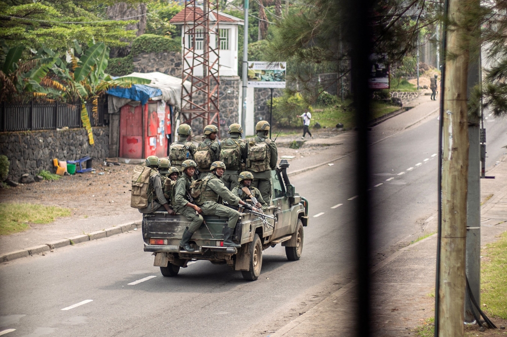 Armed men travel in a pickup truck, devoid of any insignia or markings, as they drive through a street in Goma on January 28, 2025. (Photo by AFP)