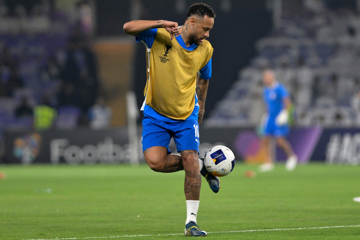 (FILES) Hilal's Brazilian forward #10 Neymar controls the ball as he warms up ahead of the AFC Champions League group B football match between UAE's Al-Ain and Saudi's Al-Hilal at the Hazza bin Zayed Stadium in al-Ain on October 21, 2024. (Photo by Adel AL-NAIMI / AFP)
