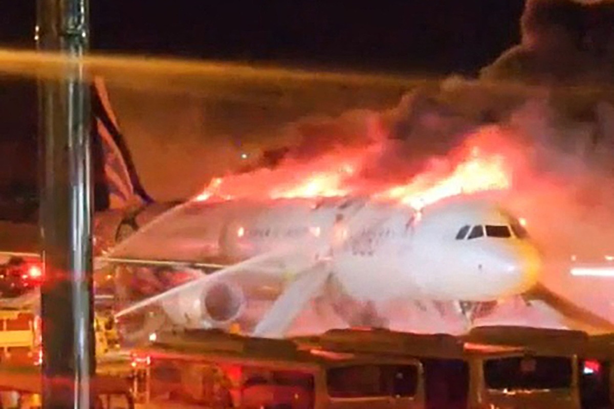 Fire authorities work to extinguish a fire that broke out on an Air Busan passenger plane at Gimhae International Airport in Busan on January 28, 2025. Photo by YONHAP / AFP