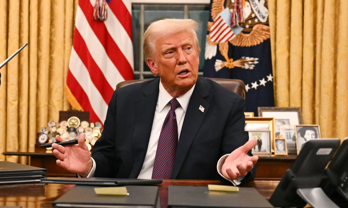 US President Donald Trump speaks to journalists about TikTok as he signs executive orders in the Oval Office of the White House in Washington, DC, on January 20, 2025. (Photo by Jim WATSON / POOL / AFP)
