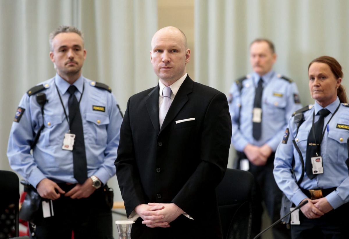 Mass killer Anders Behring Breivik is seen surrounded by prison guards on the fourth and last day in court in Skien prison Norway March 18 2016 REUTERS Lise Asreud