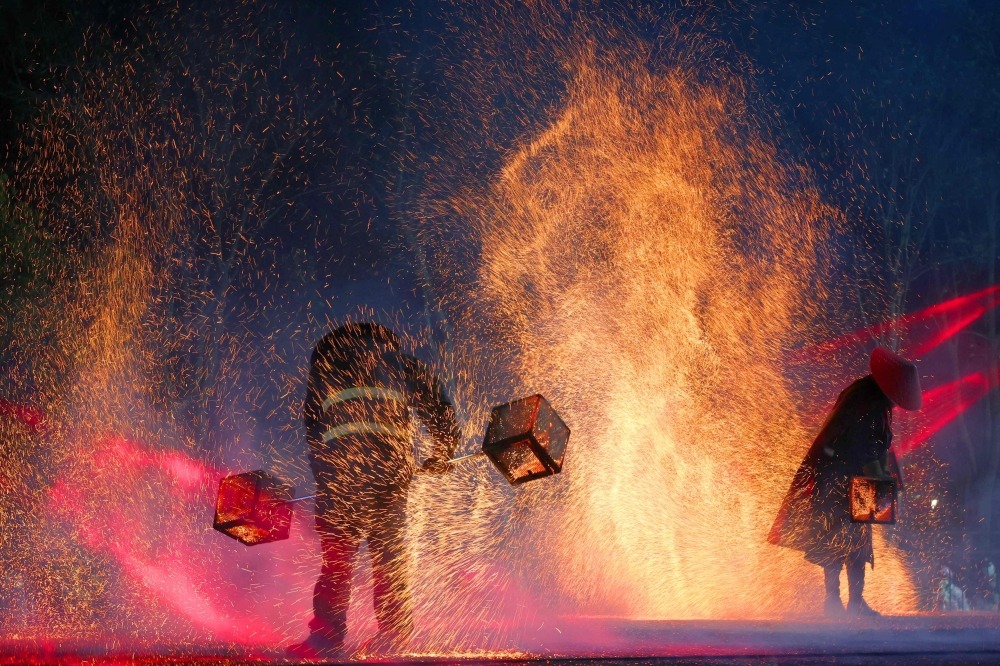 Performers create sparks with molten steel at a Lunar New Year lantern festival in Nantong, in China's eastern Jiangsu province on January 27, 2025. The Year of the Snake begins on January 29. (Photo by AFP)