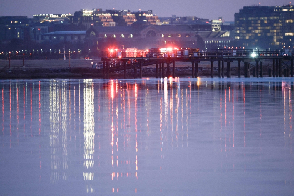 Emergency response units assemble at Ronald Reagan Washington Airport as search and rescue operations are underway in the Potomac River on January 30, 2025 in Arlington, Virginia. Win McNamee/Getty Images/AFP