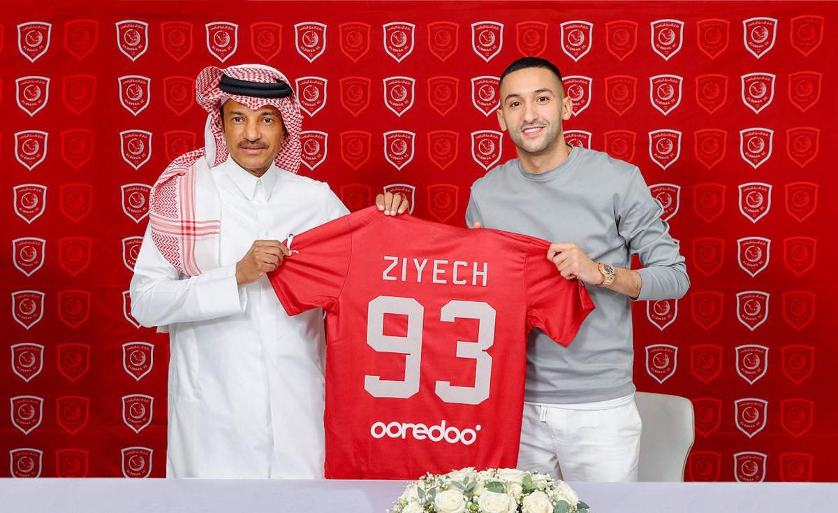 Hakim Ziyech poses with his Al Duhail jersey along with club’s official.   