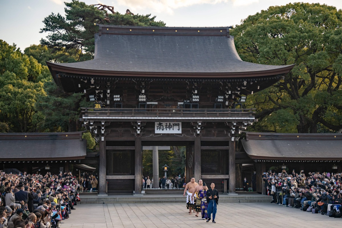 Mongolian born sumo wrestler and new yokozuna, or grand champion, Hoshoryu (back) takes part in the ring-entering ceremony at Meiji Shrine in Tokyo on January 31, 2025. (Photo by Philip FONG / AFP)