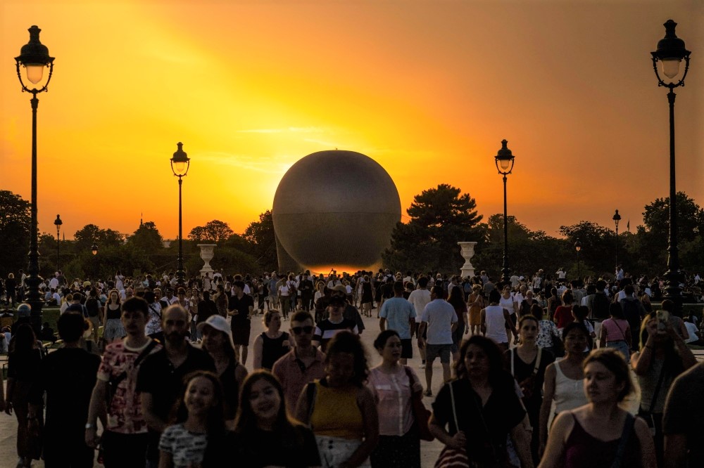 File: Visitors gather in front of the Olympic cauldron, an air balloon, lit with the Olympic flame in Paris on July 30, 2024. (Photo by Andrej Isakovic / AFP)