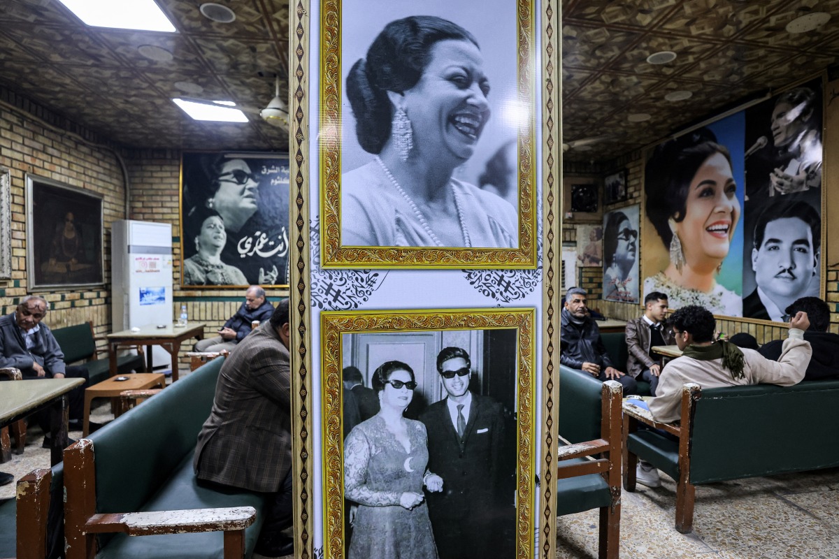 People sit at the Umm Kulthum cafe in the old city of Baghdad on January 27, 2025. (Photo by AHMAD AL-RUBAYE / AFP)
