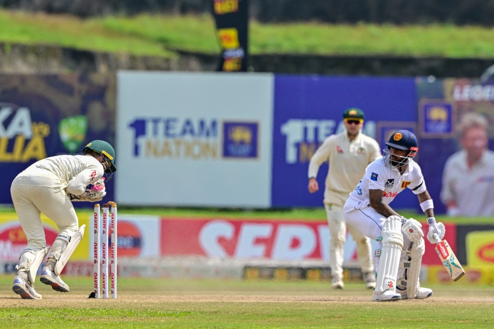 Australia's Alex Carey (L) stumps out Sri Lanka's Kusal Mendis (R) during the fourth day of the first Test cricket match between Sri Lanka and Australia at the Galle International Cricket Stadium in Galle on February 1, 2025. (Photo by Ishara S. Kodikara / AFP)