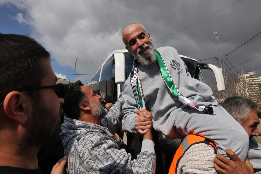 A former Palestinian prisoner is cheered upon his arrival in Ramallah on buses of the International Committee of the Red Cross (ICRC) on February 1, 2025. (Photo by Ahmad Gharabli / AFP)
