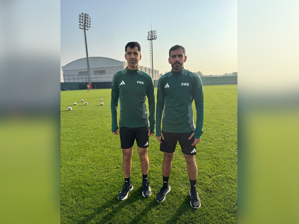 Qatar's International referees Abdulrahman Al Jassim (left) and Salman Falahi pose for a photo.