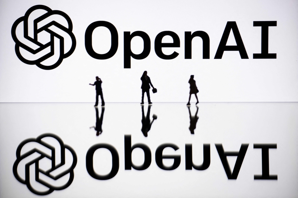 (Files) This illustration photograph taken on October 30, 2023, in Mulhouse, eastern France, shows figurines next to a screen displaying a logo of OpenAI. (Photo by Sebastien Bozon / AFP)