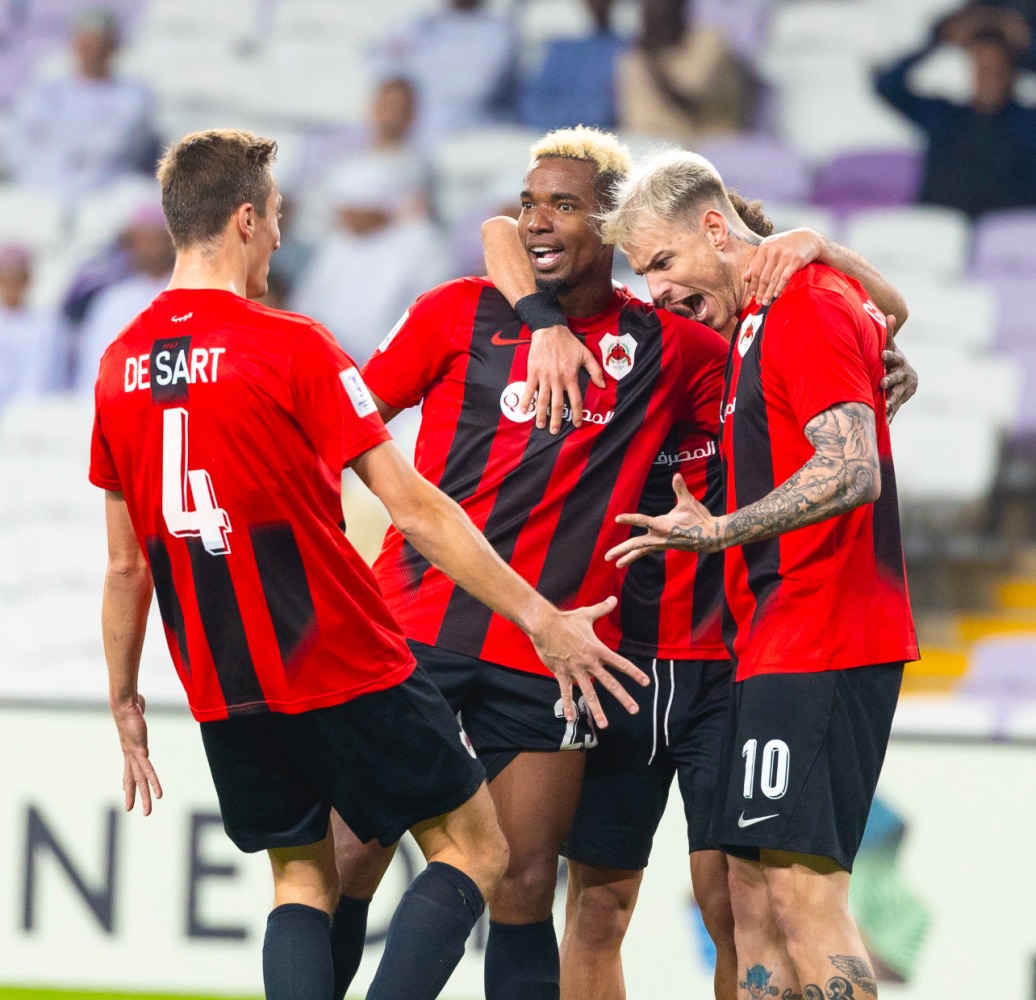 Al Rayyan players celebrate after Roger Guedes (right) scored their second goal.