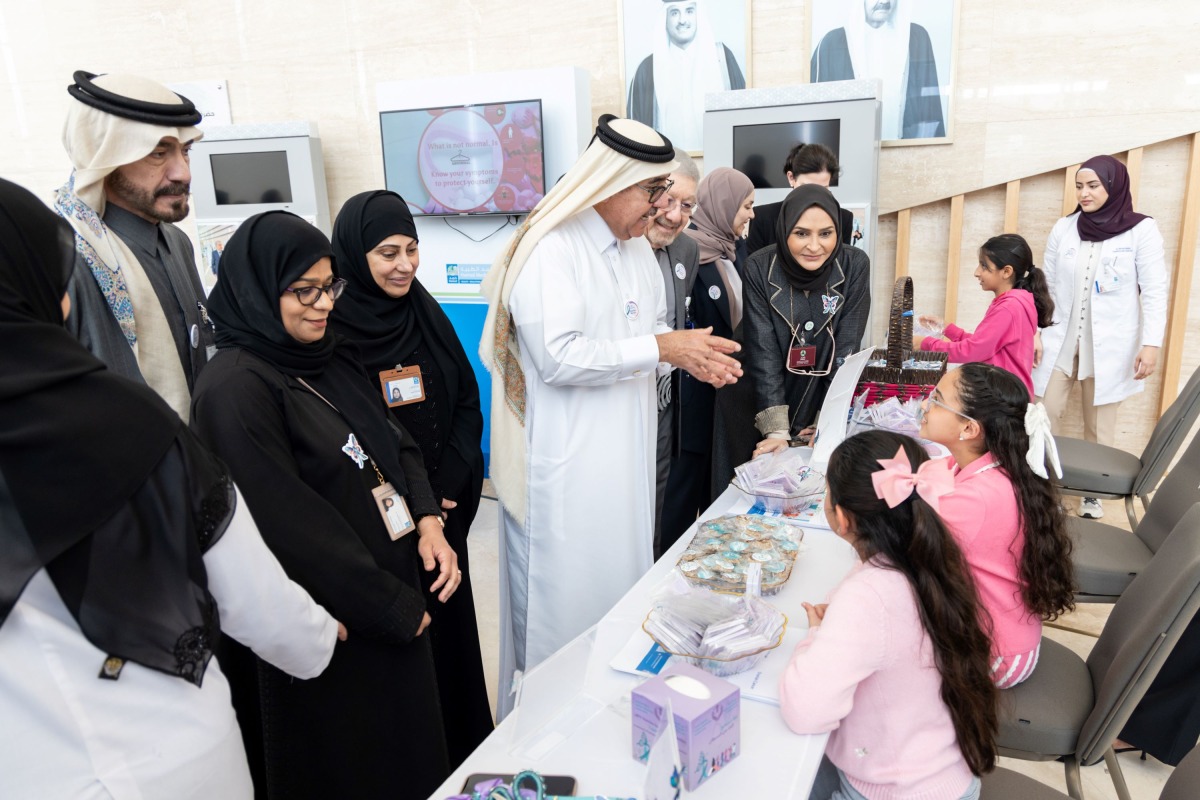 Dr. Hilal interacts with a staff manning one of the stands