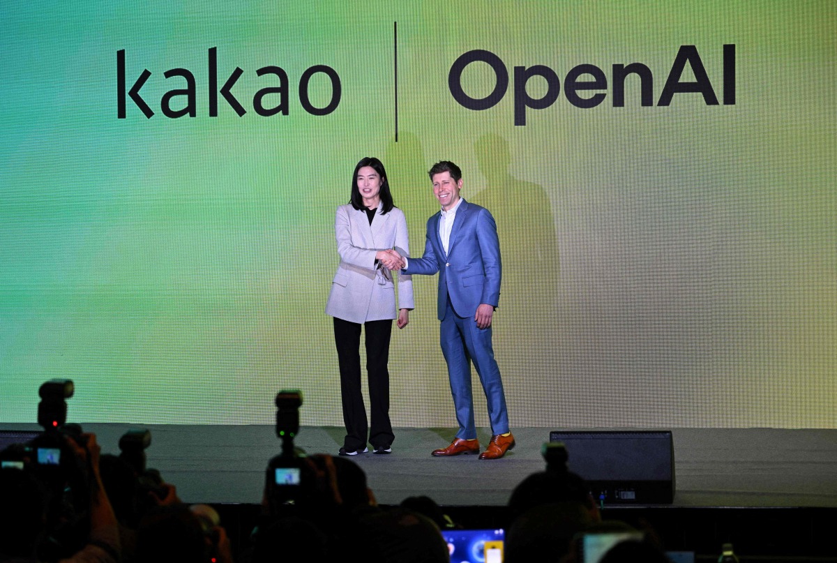 Open AI CEO Sam Altman (R) and Kakao CEO Chung Shin-a (L) pose for photos during a press conference at a hotel in Seoul on February 4, 2024. (Photo by Jung Yeon-je / AFP)