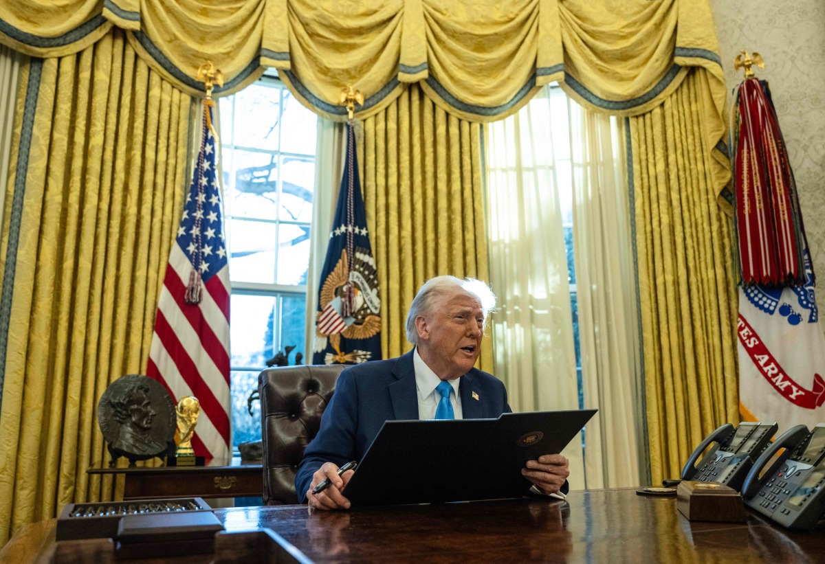 US President Donald Trump speaks to the press as he signs executive orders in the Oval Office of the White House on February 4, 2025 in Washington, DC. (Photo by ANDREW CABALLERO-REYNOLDS / AFP)
