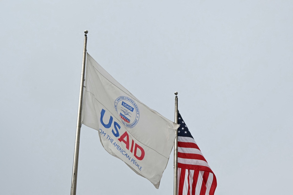 (FILES) A USAID and American flag fly before Congressional Democrats hold news conference outside of United States Agency for International Development (USAID) headquarters in Washington, DC, on February 3, 2025. (Photo by Mandel NGAN / AFP)
