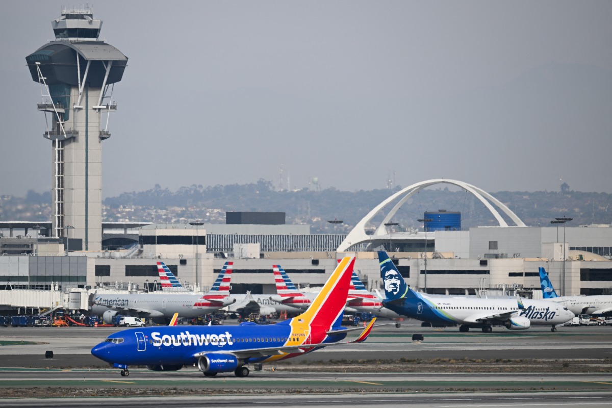 Photo used for representational purposes. A Southwest Airlines Boeing 737-700 airplane taxis past American Airlines and Alaska Airlines airplanes at Los Angeles International Airport (LAX) in Los Angeles, California on January 31, 2025. Photo by Patrick T. Fallon / AFP.
