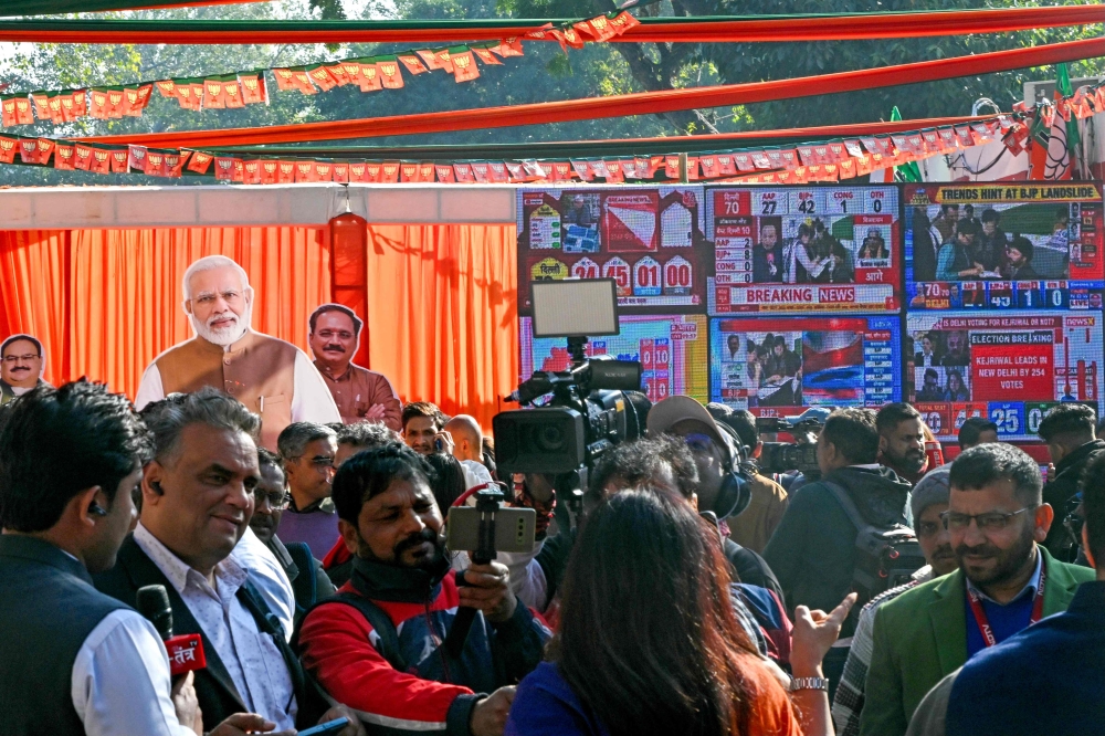 Journalists gather at Bharatiya Janata Party state headquarters in New Delhi on February 8, 2025, as BJP leads in Delhi legislative assembly polls. (Photo by Arun SANKAR / AFP)