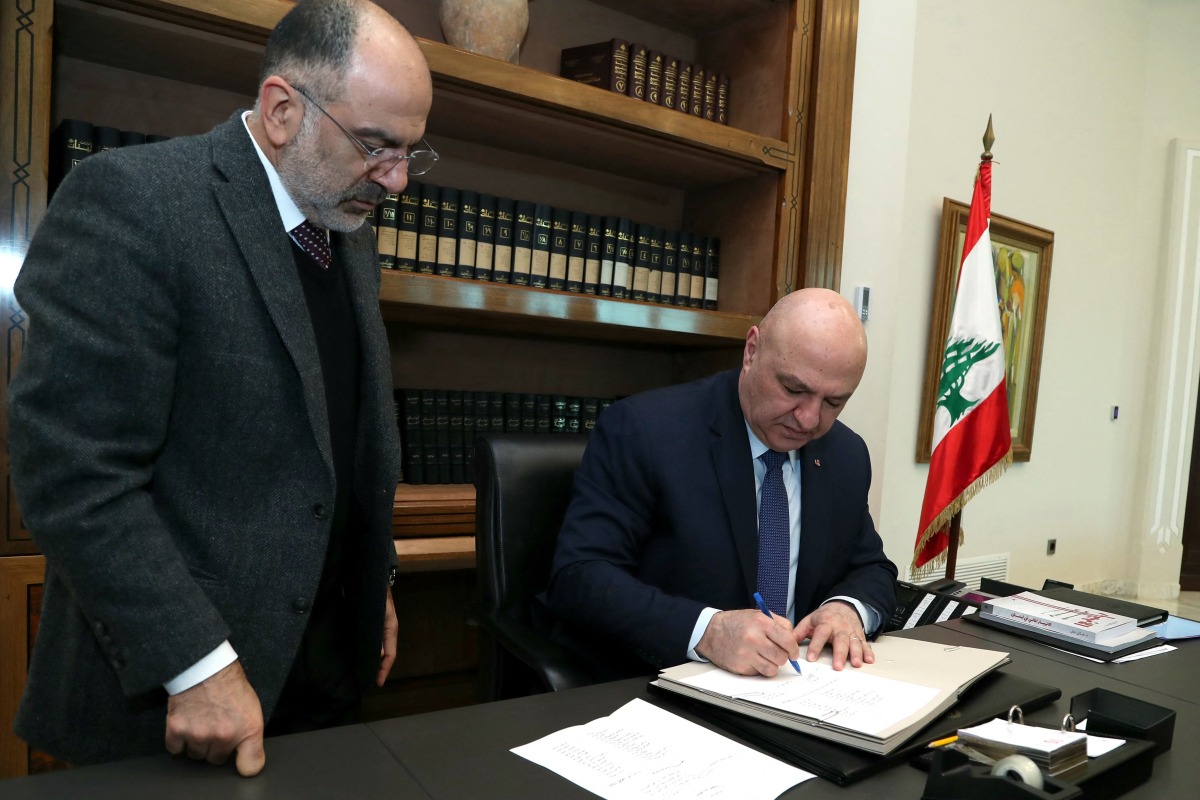 This handout picture released by the Lebanese presidency shows President Joseph Aoun (C) signing a decree at the presidential palace in Baabda, east of Beirut on February 8, 2025. (Photo by Lebanese Presidency / AFP)