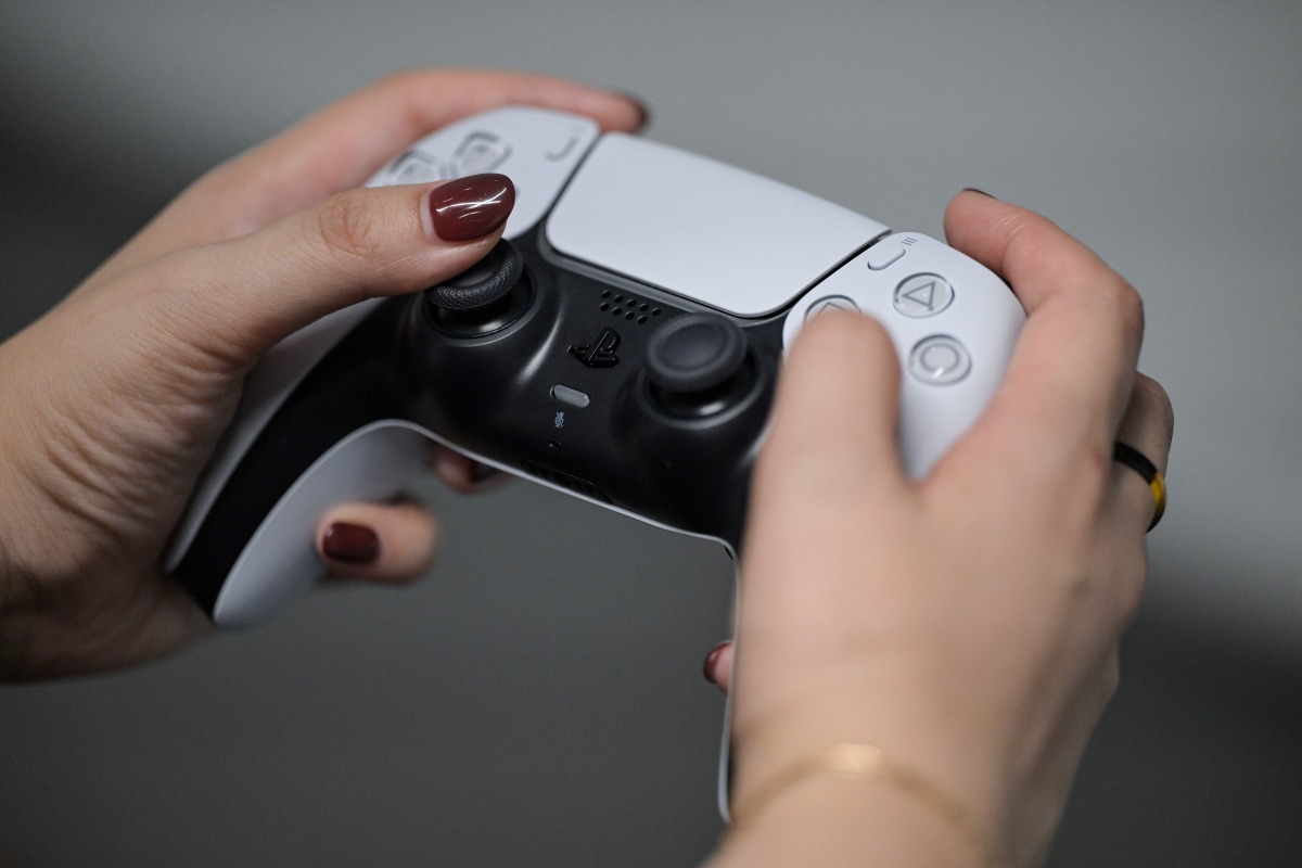 A PlayStation employee demonstrates how to use the PlayStation 5 Pro console, at the Sony headquarters building in central Tokyo on November 27, 2024. Photo by Richard A. Brooks / AFP