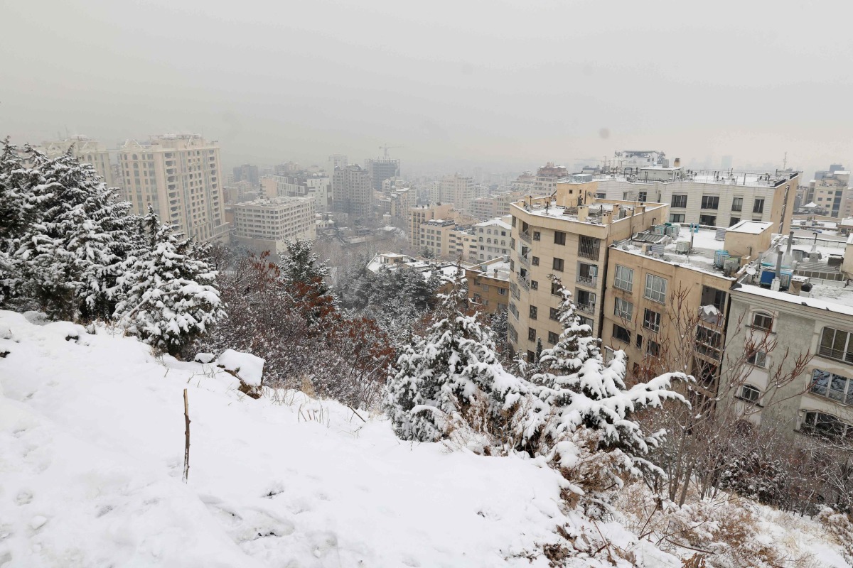 A layer of snow blankets Tehran as seen from the Tochal mountain resort, on February 9, 2025. (Photo by ATTA KENARE / AFP)
