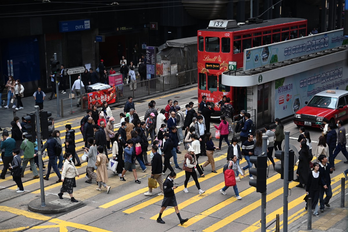 People cross an intersection in the Central business district in Hong Kong. AFP file photo.