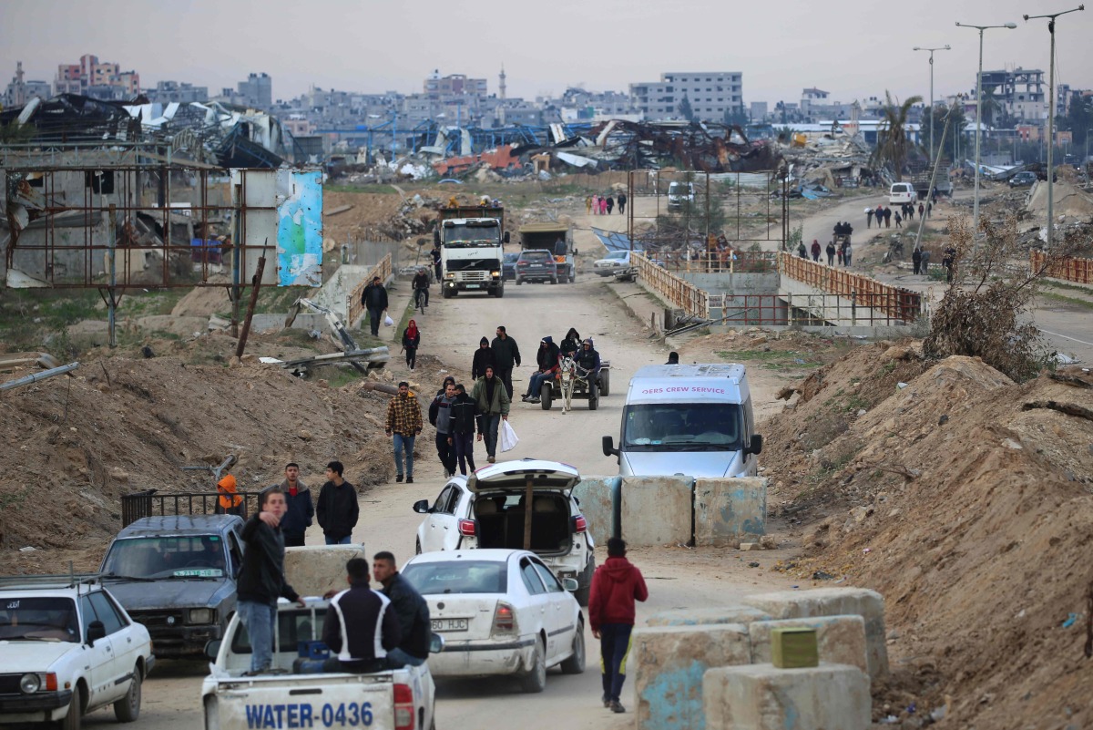 Displaced Palestinians cross the Netzarim corridor as they make their way to the northern parts of the Gaza Strip on February 9, 2025. (Photo by Eyad BABA / AFP)
