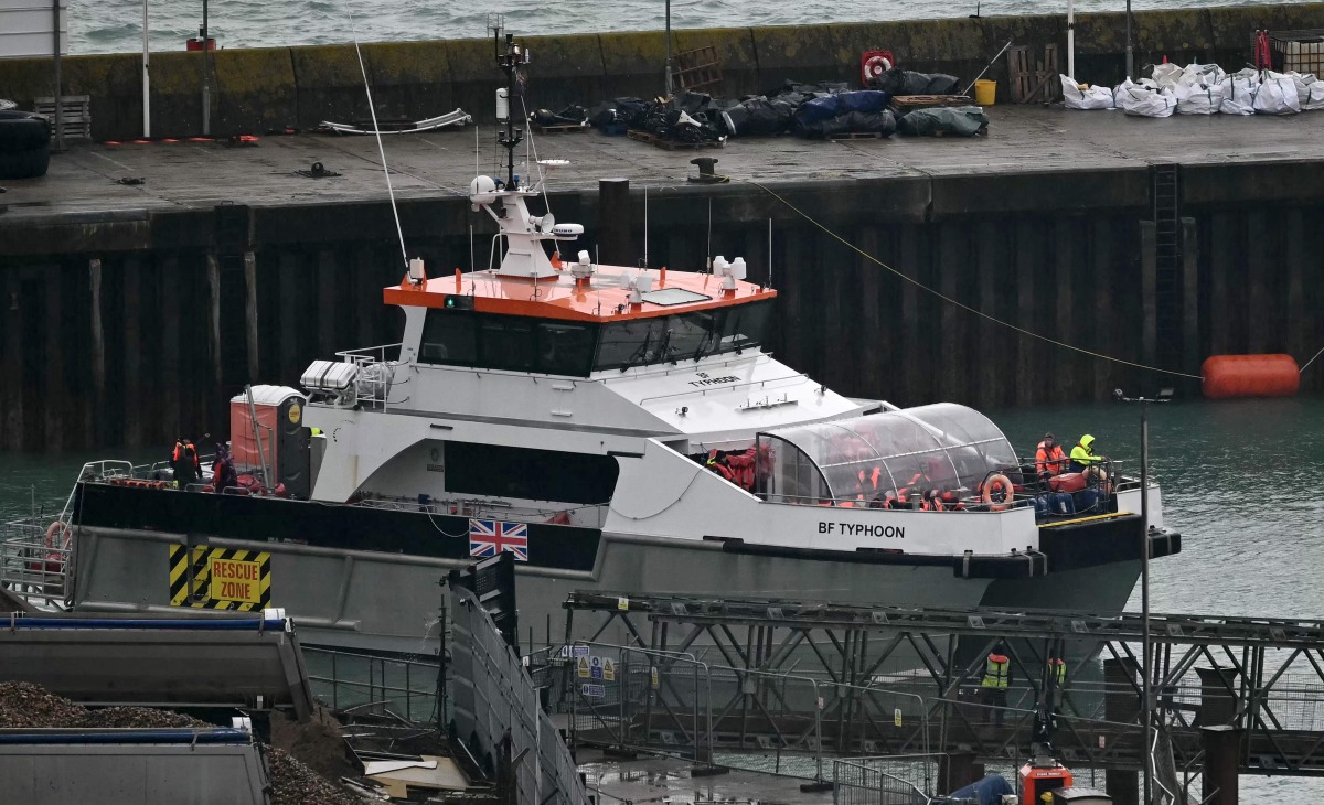 UK Border Force vessel 'Typhoon', carrying migrants picked up at sea attempting to cross the English Channel from France, arrives at the Marina in Dover, southeast England, on February 9, 2025. (Photo by Ben STANSALL / AFP)