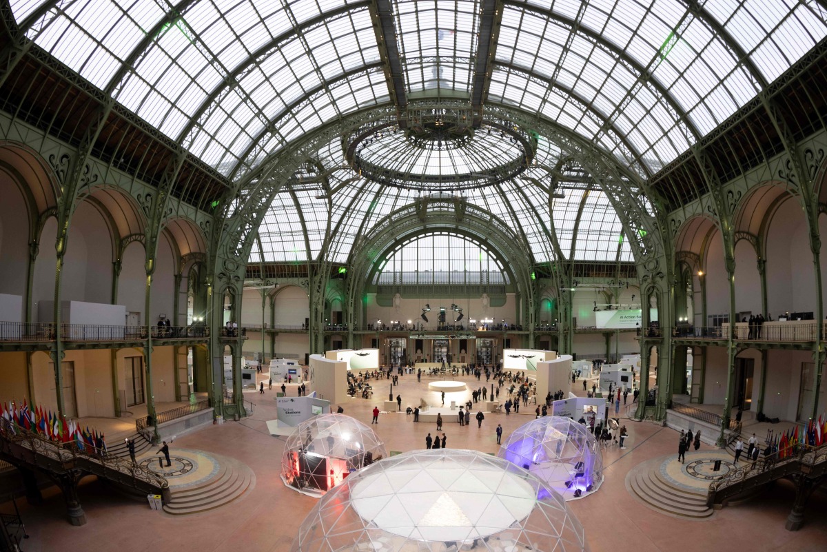 People take part in the Artificial Intelligence (AI) Action Summit, at the Grand Palais, in Paris, on February 10, 2025. (Photo by JOEL SAGET / AFP)
