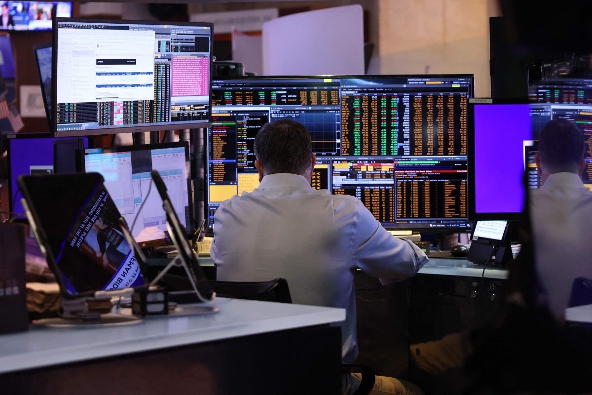 A file photo showing traders on the floor of the New York Stock Exchange during morning trading in New York City, US. (AFP)