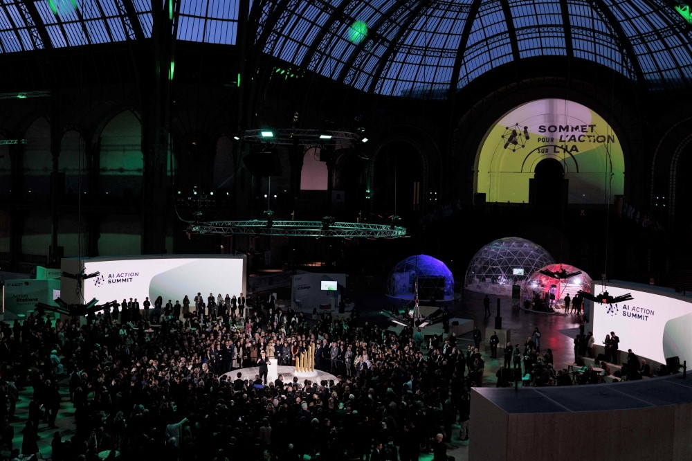 France's President Emmanuel Macron (centre) delivers a speech during a closing event for the first day of the Artificial Intelligence (AI) Action Summit, at the Grand Palais, in Paris, on February 10, 2025. (Photo by Joel Saget / AFP)
