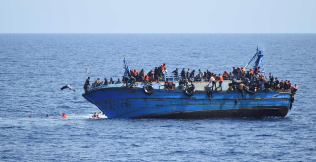 Migrants are seen on a capsizing boat before a rescue operation off the coast of Libya in this photo released by the Italian Marina Militare. (File photo: Reuters).

