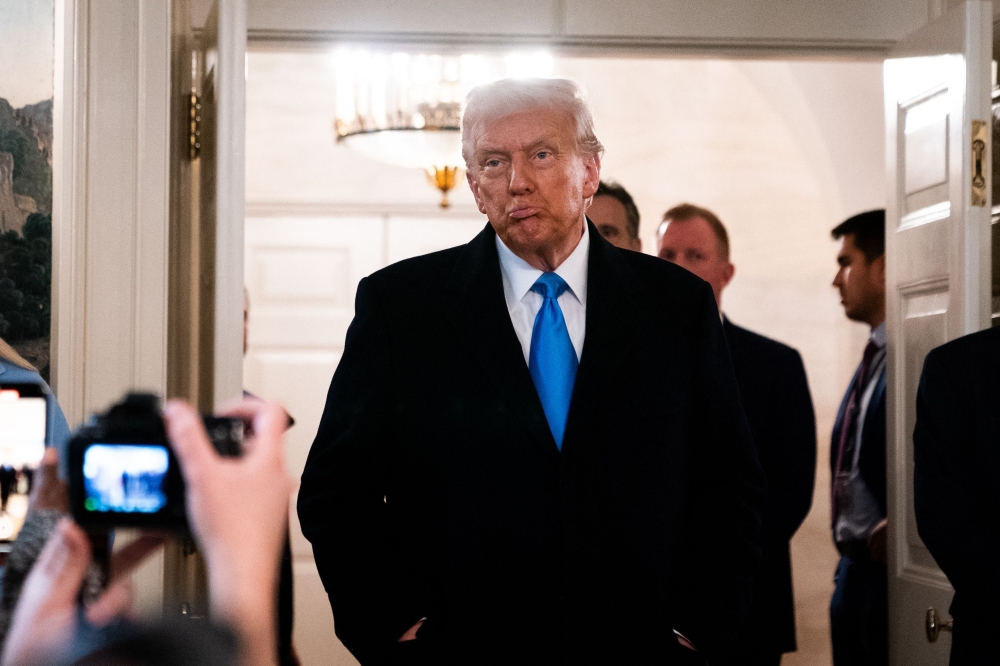 US President Donald Trump arrives to speak to reporters in Washington, DC, on February 11, 2025. (Photo by Allison Robbert / AFP)