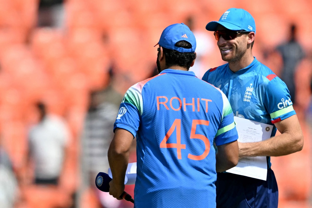 India's captain Rohit Sharma (L) and England's captain Jos Buttler interact during toss at the start of the third one-day international (ODI) cricket match between India and England at the Narendra Modi Stadium in Ahmedabad on February 12, 2025. (Photo by Sajjad HUSSAIN / AFP)