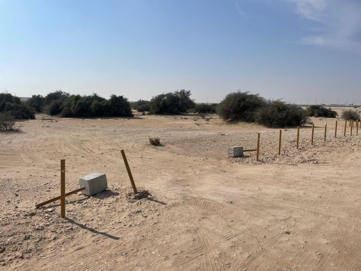 A fence around a meadow broken by visitors.