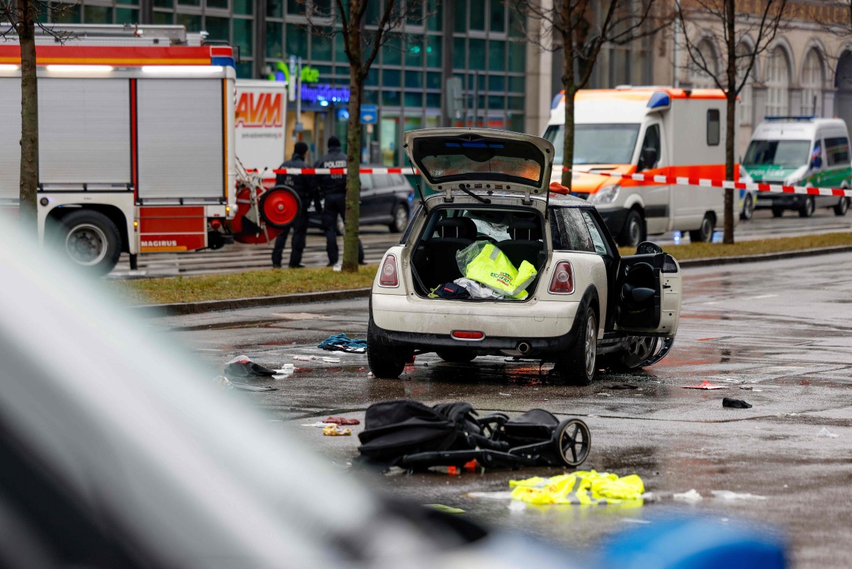 Members of the emergency services work at the scene where a car drove into a crowd in the southern German city of Munich on February 13, 2025 leaving several people injured, police said. Photo by Michaela STACHE / AFP