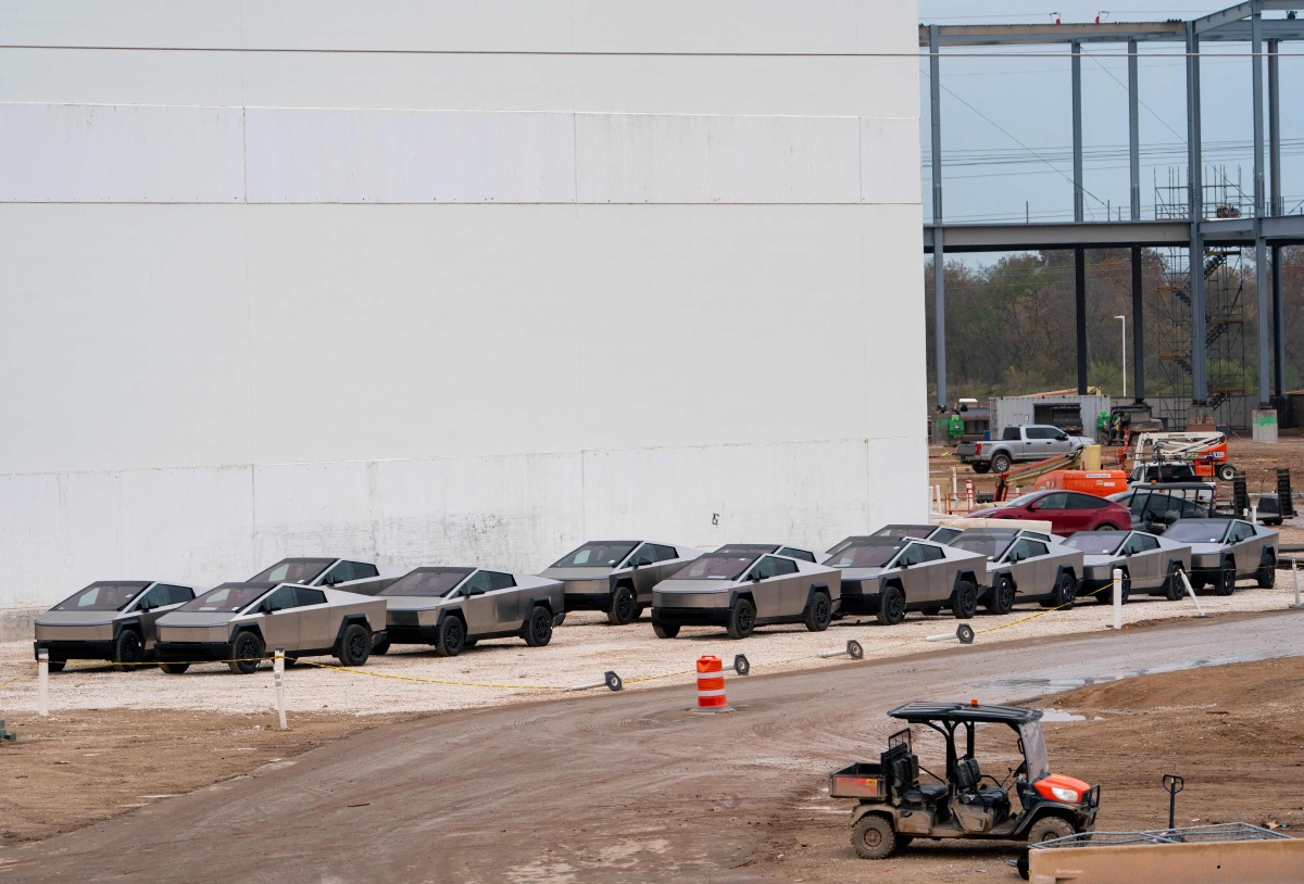 (FILES) Newly manufactured Tesla Cybertrucks are parked outside the company's Giga Texas factory on December 13, 2023, in Austin, Texas. (Photo by SUZANNE CORDEIRO / AFP)
