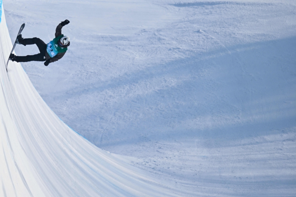 Afghanistan's Ahmad Habibzi competes in the men's snowboard halfpipe qualification during the Harbin 2025 Asian Winter Games in Yabuli, Northeast China's Heilongjian province on February 12, 2025. (Photo by Hector Retamal / AFP)