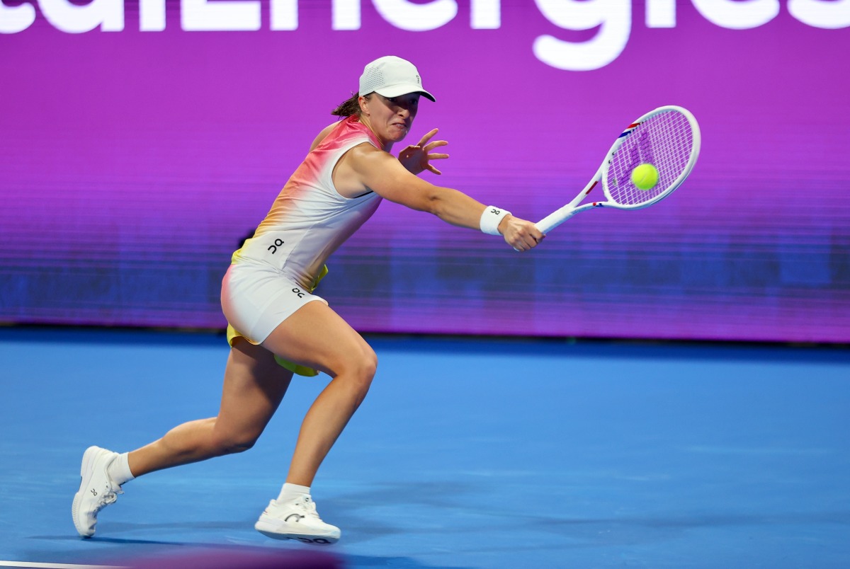 Poland's Iga Swiatek hits a return to Kazakhstan's Elena Rybakina during their quarter-final yesterday. 