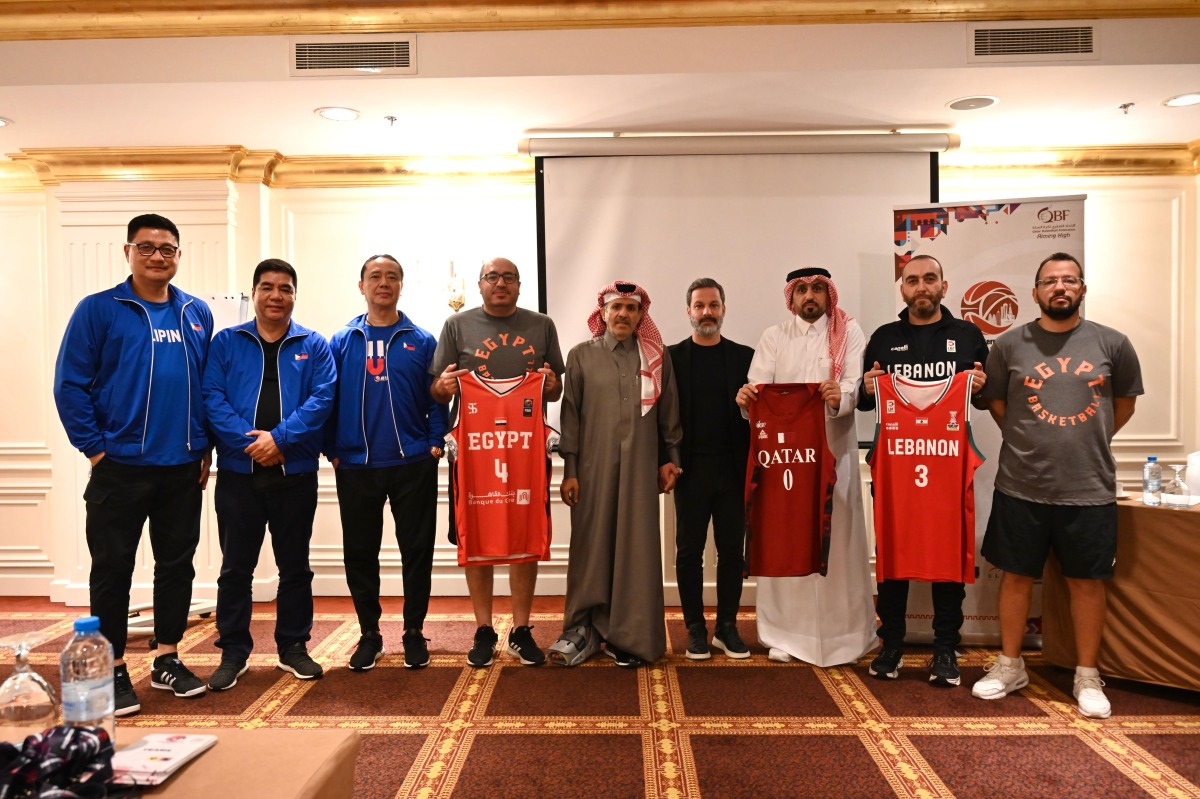 Representatives of participating nations pose with their team jerseys. 