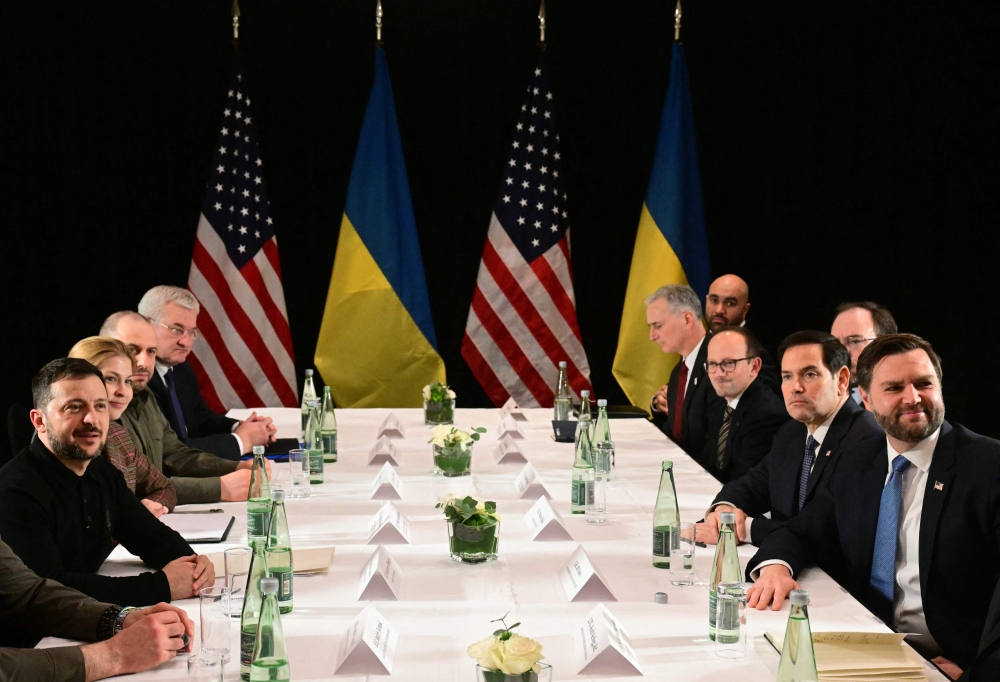 US Vice President JD Vance (R), US Secretary of State Marco Rubio (2nd R) and Ukrainian President Volodymyr Zelensky (L) meet on the sidelines of the 61st Munich Security Conference (MSC) in Munich, southern Germany on February 14, 2025. (Photo by Tobias Schwarz / AFP)