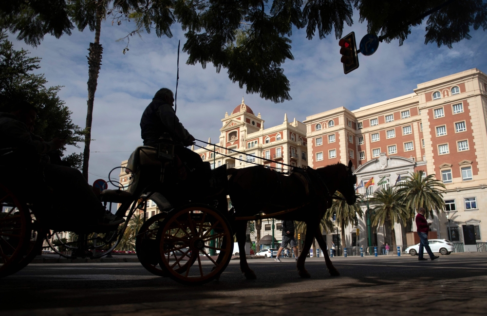 Tourists visit the town of Malaga in a horse-drawn carriage on February 10, 2025. (Photo by Jorge Guerrero / AFP)
 