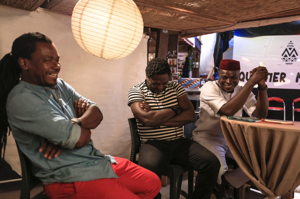 Landry Bassy (L), an artist, Nabe Daone (C), a film director and Xzafrane (R), a rapper, react during a question and answer session at Quartier Mozart, in Yaounde, on December 13, 2024. (Photo by AFP)