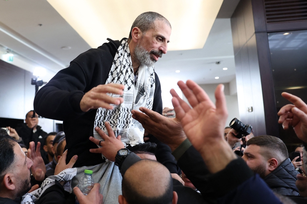 A former Palestinian prisoner is welcomed by relatives upon arriving in the occupied West Bank city of Ramallah on February 15, 2025. (Photo by Zain Jaafar / AFP)
 