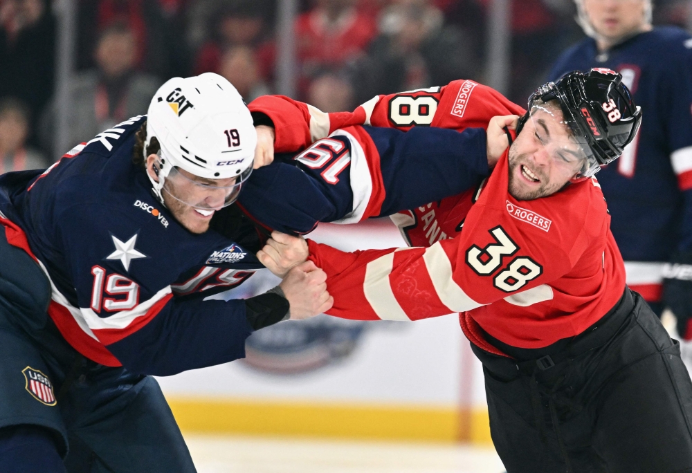 Matthew Tkachuk #19 of Team USA fights with Brandon Hagel #38 of Team Canada during the first period in the 4 Nations Face-Off game at the Bell Centre on February 15, 2025 in Montreal, Quebec, Canada. Minas Panagiotakis/Getty Images/AFP 