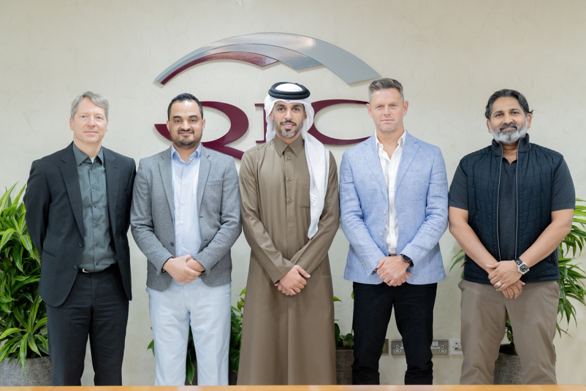 QIC Group CEO Salem Al Mannai pose for a group photo with other officials.