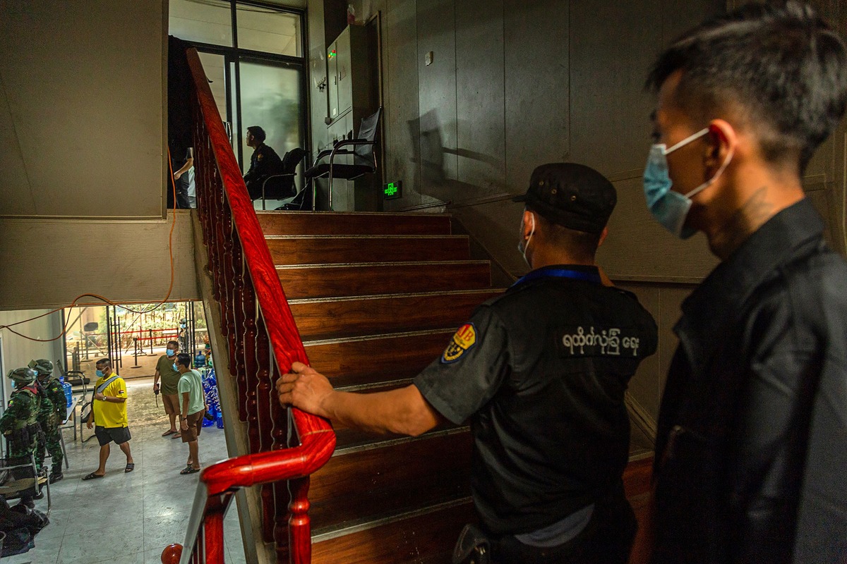 Members of the Karen Border Guard Force (BGF) carry out an inspection at a work place during a crackdown operation on illicit activity linked to scam centres in Shwe Kokko in Myanmar's eastern Myawaddy township on February 18, 2025. (Photo by AFP)
