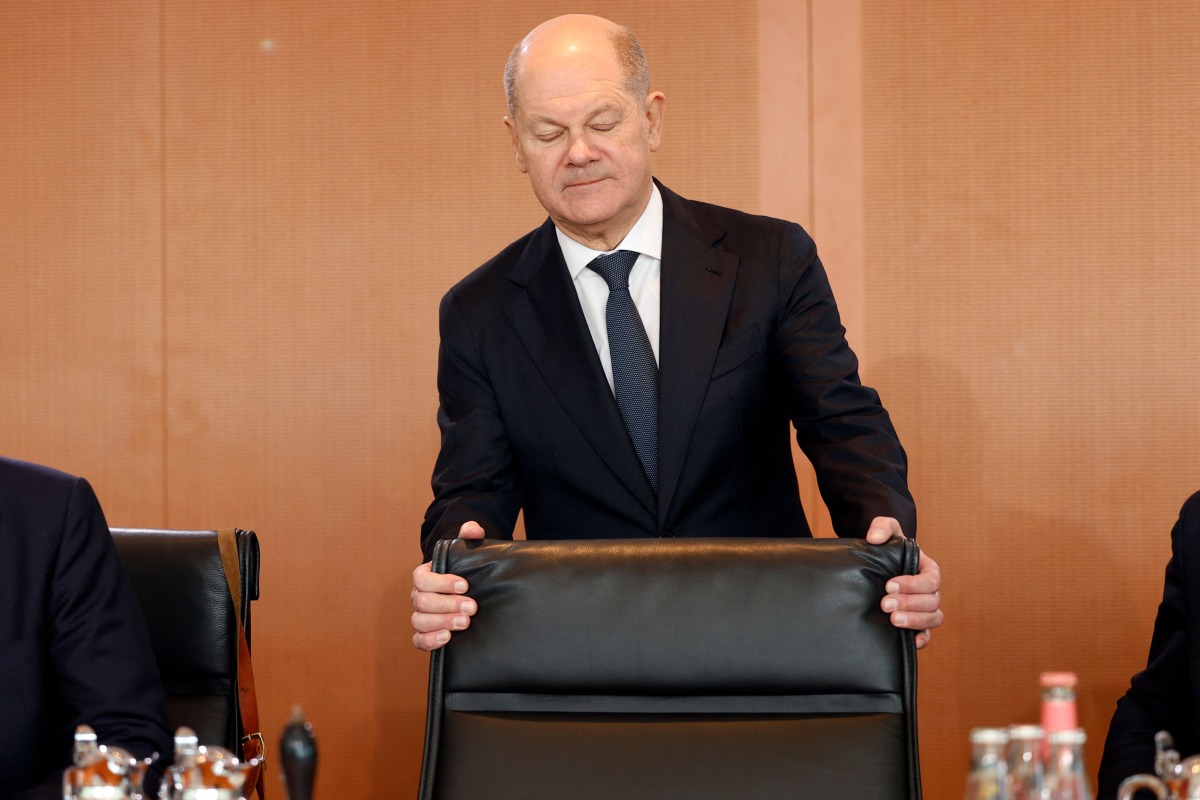 German Chancellor Olaf Scholz holds his chair as he arrives for the weekly meeting of the German cabinet at the Chancellery in Berlin on February 19, 2025. (Photo by Odd ANDERSEN / AFP)